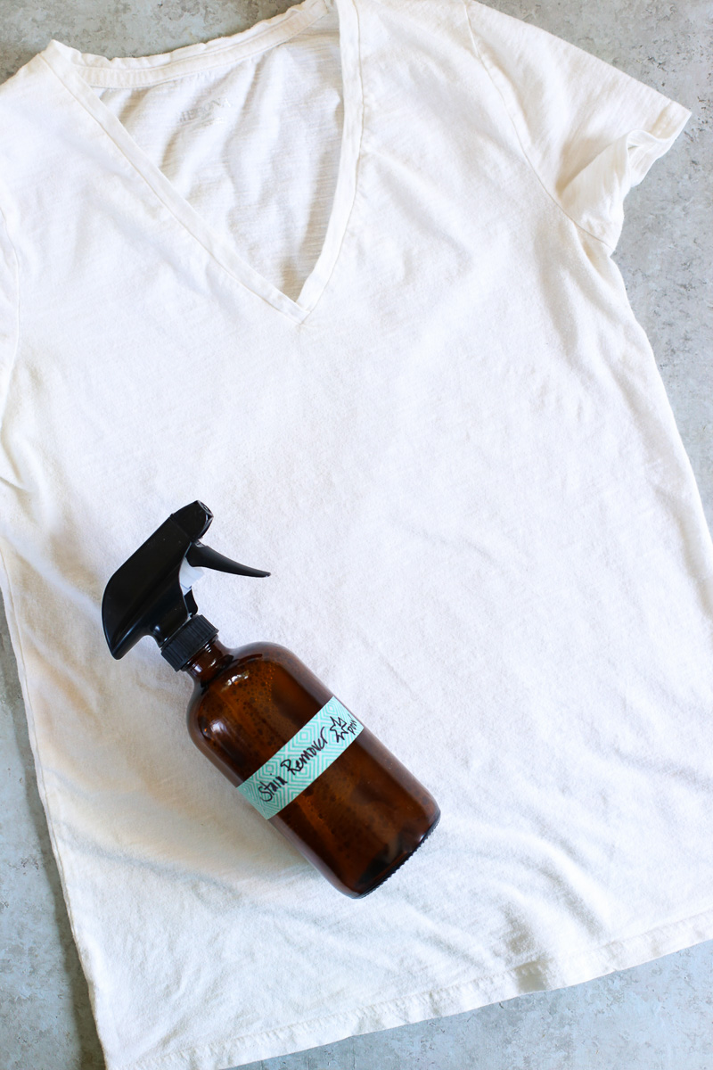 Stain remover bottle laying on a white shirt.