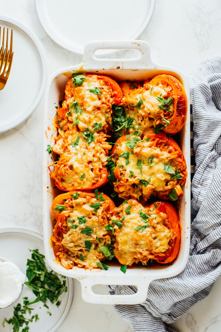 Stuffed peppers cooked in a white baking dish.
