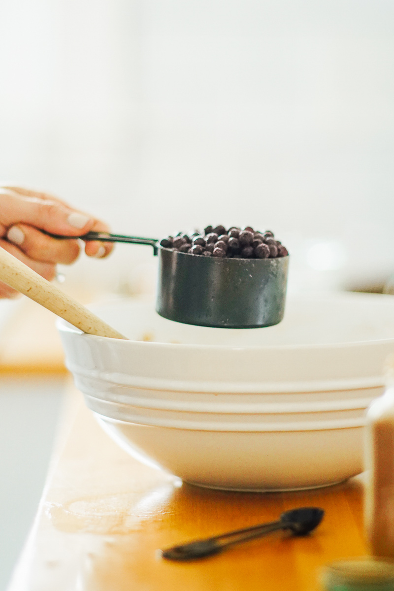 Adding the blueberries to the ingredients in the large bowl.
