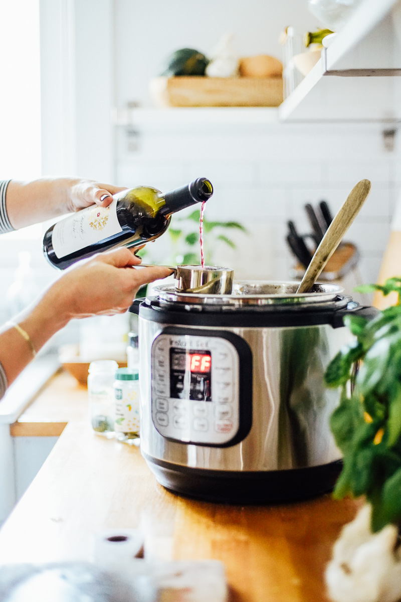 Pouring wine into the Instant Pot.