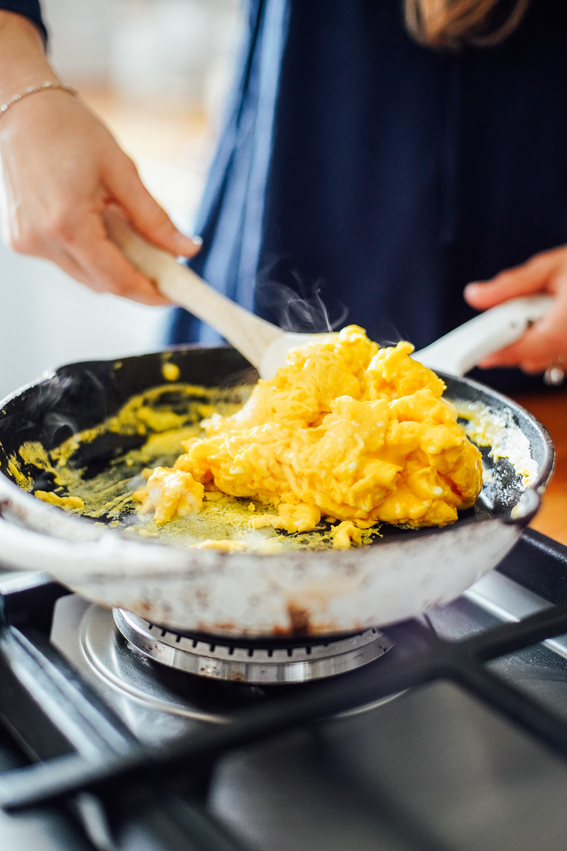 Scrambling the eggs in a skillet.