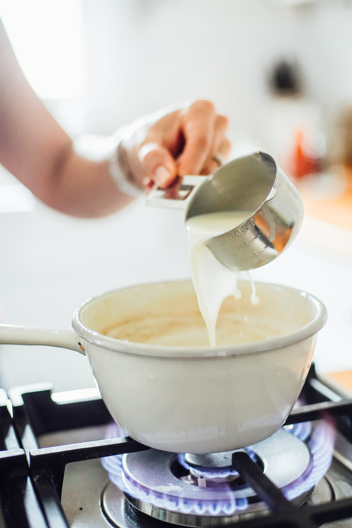 Warming milk in a saucepan to make a chai latte.