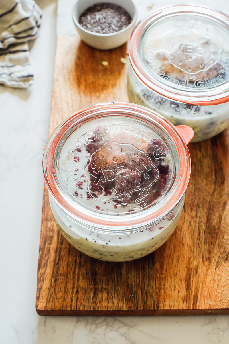Jars of overnight oats on the counter with a lid.