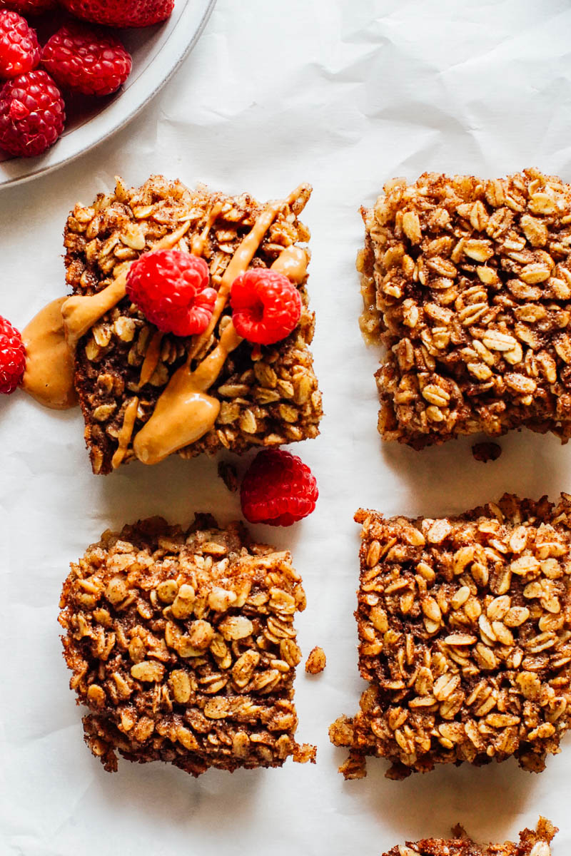 Baked oatmeal cut into bars with peanut butter and fruit.