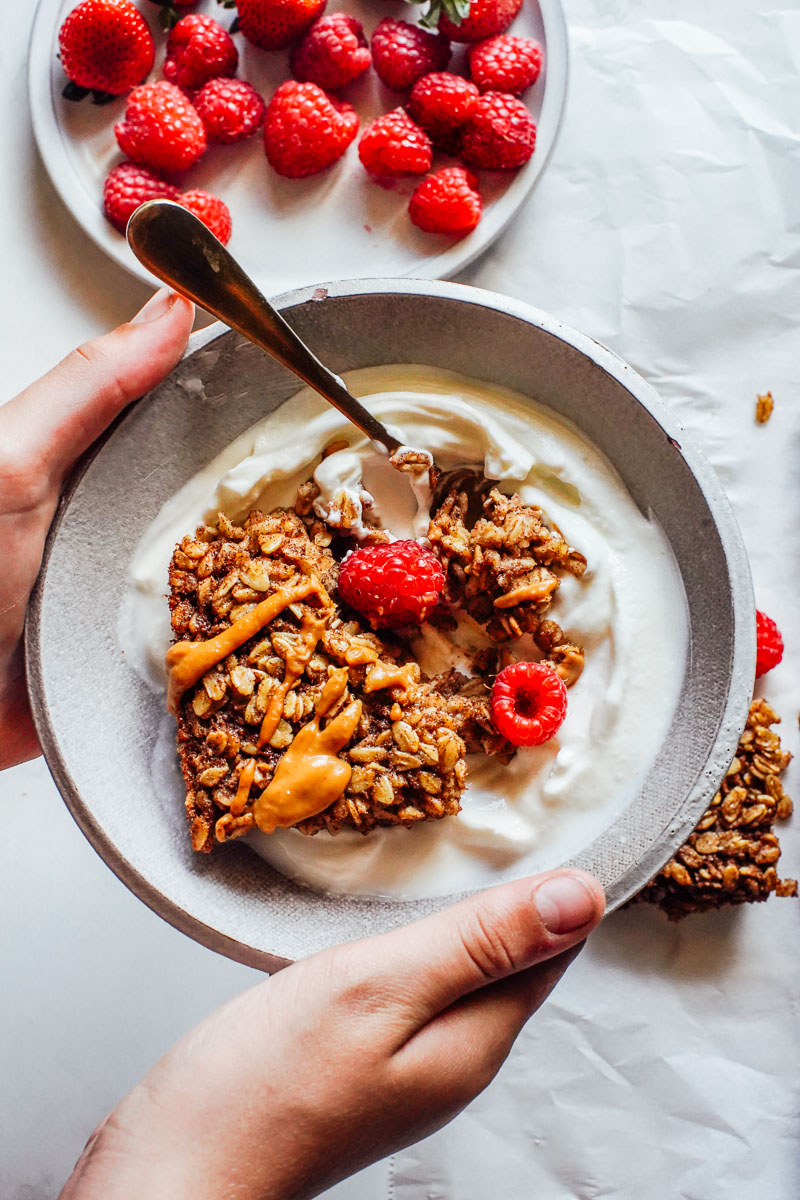 Baked oat bar in a bowl with yogurt.