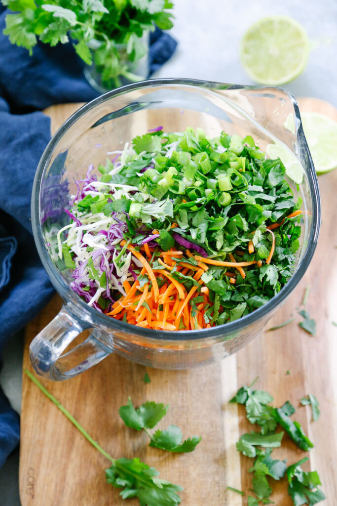 All slaw ingredients in a bowl. 