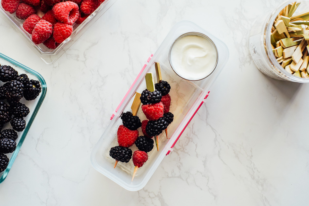 Yogurt dip with berries on a skewer for dipping. 