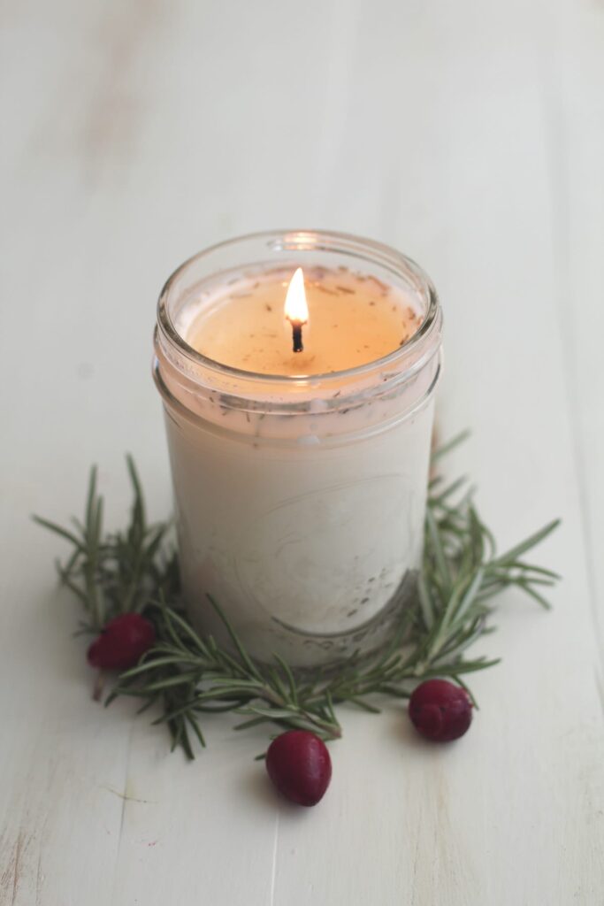 Lit soy wax candle on a table. 
