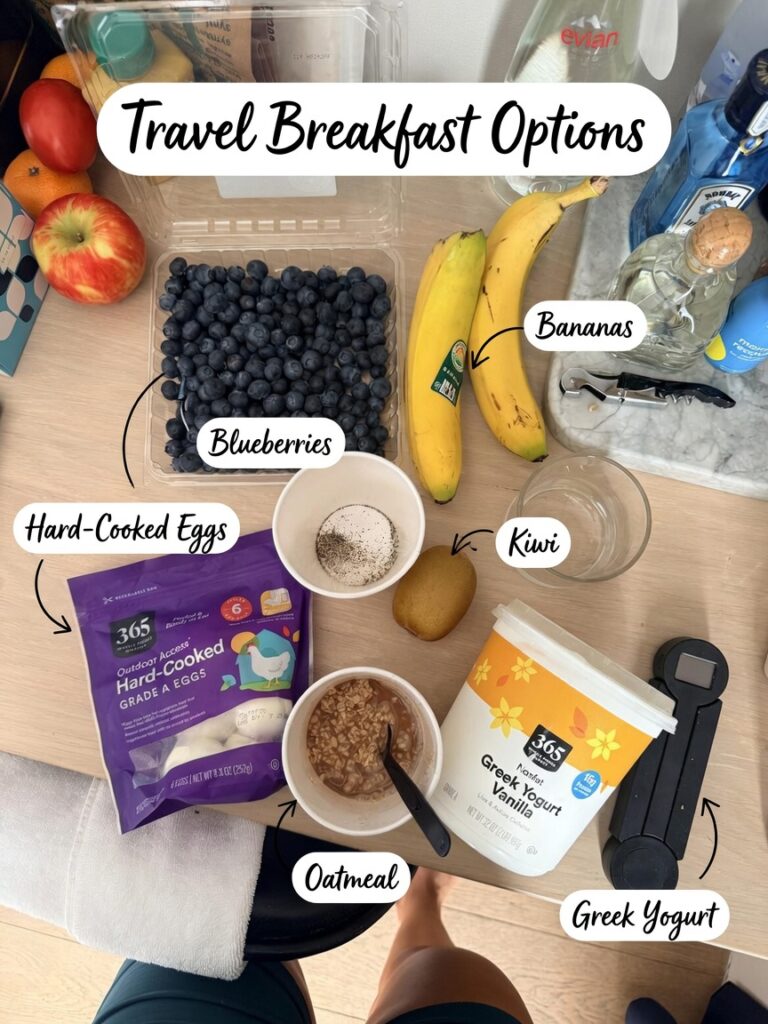 Travel breakfast ingredients: hard-cooked eggs, Greek yogurt, blueberries, bananas, kiwi, and oatmeal with PB Fit ready for hot water